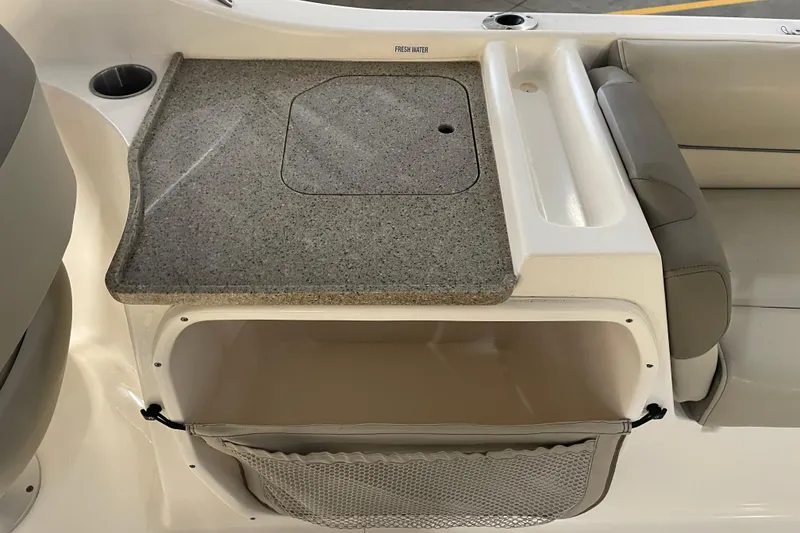 Slide: The Image of 2021 Key West 239 DFS boat interior with storage compartment and countertop. - 34