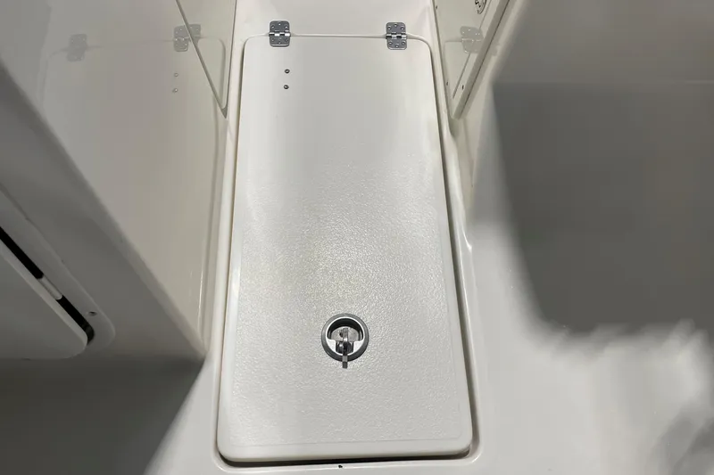 Slide: The Image of 2021 Key West 239 DFS boat storage compartment with secure latch and hinges. - 37