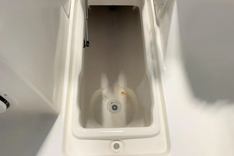 Slide: The Image of Storage compartment of 2021 Key West 239 DFS boat, featuring a clean, white interior. - 38