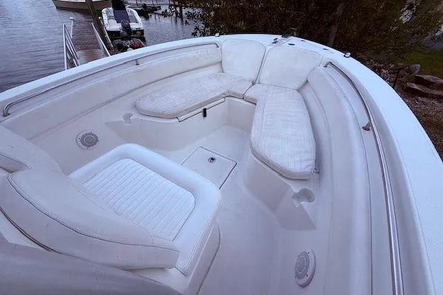 Slide: The Image of 2013 Sea Fox 226 Commander boat interior with cushioned seating and storage compartments. - 10