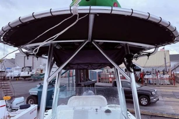 Slide: The Image of 2013 Sea Fox 226 Commander boat with T-top in a marina setting. - 12