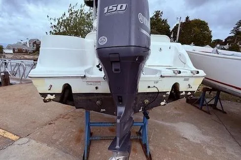 Slide: The Image of 2013 Sea Fox 226 Commander boat with 150 HP outboard motor on stand. - 15