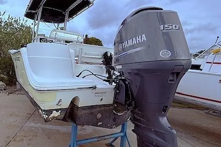 Slide: The Image of 2013 Sea Fox 226 Commander boat with Yamaha 150 outboard motor, docked outdoors. - 16