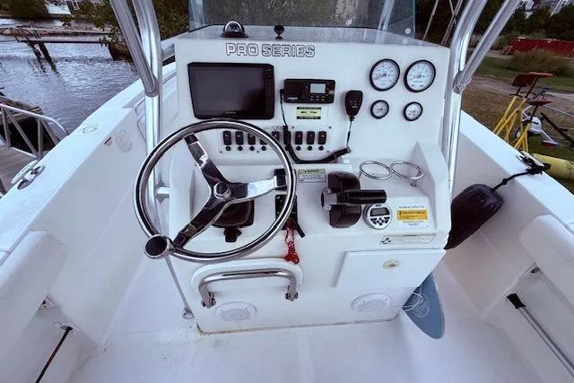 Slide: The Image of 2013 Sea Fox 226 Commander boat console with steering wheel, gauges, and navigation equipment. - 4