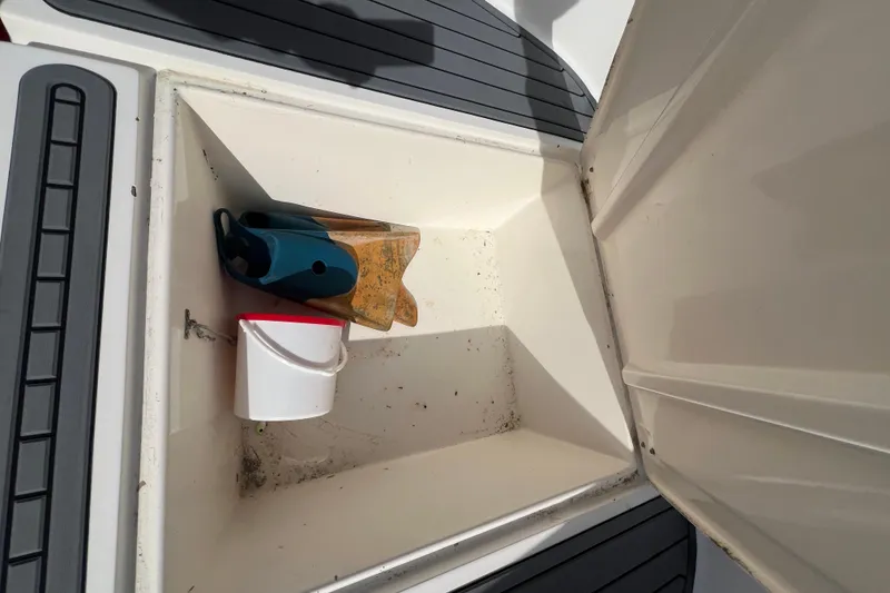 Slide: The Image of Storage compartment on a 1995 Mako 221 Center Console boat with cleaning supplies. - 11