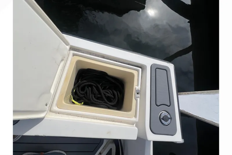 Slide: The Image of Open storage compartment on 1995 Mako 221 Center Console boat with coiled rope inside. - 15