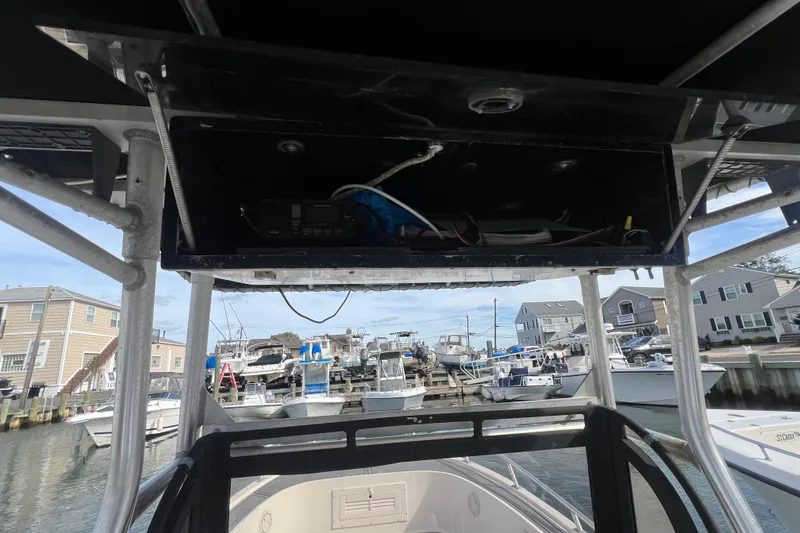 Slide: The Image of 1995 Mako 221 Center Console boat interior with marina view in the background. - 5