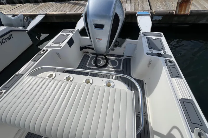 Slide: The Image of 1995 Mako 221 Center Console boat interior with engine, docked at marina. - 6