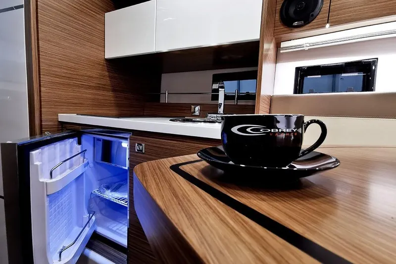 Slide: The Image of Interior of 2026 Cobrey 28 SC yacht with open fridge and branded cup. - 4