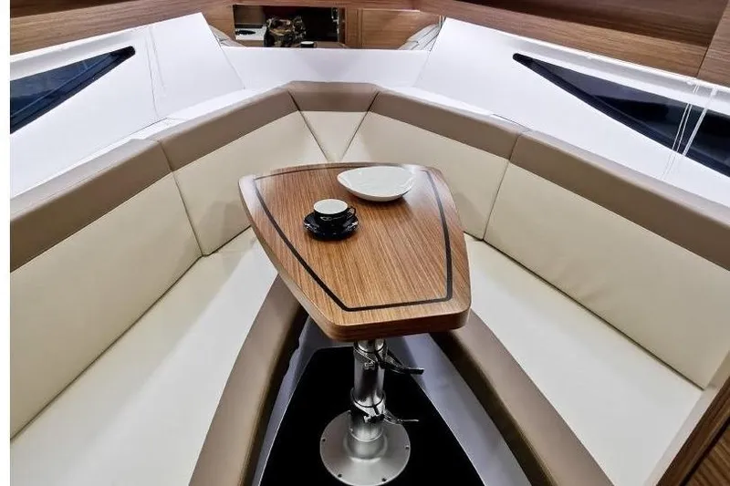 Slide: The Image of Luxurious interior of 2026 Cobrey 28 SC yacht with elegant seating and wooden table. - 5