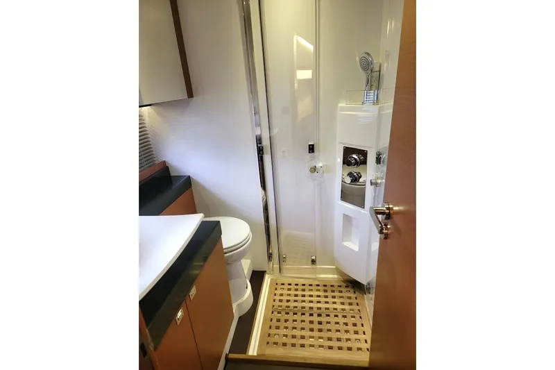 Slide: The Image of Luxurious bathroom in 2013 Prestige 500 S yacht with modern fixtures and wooden accents. - 12