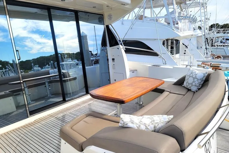 Slide: The Image of Luxurious 2013 Prestige 500 S yacht deck with seating and wooden table. - 14