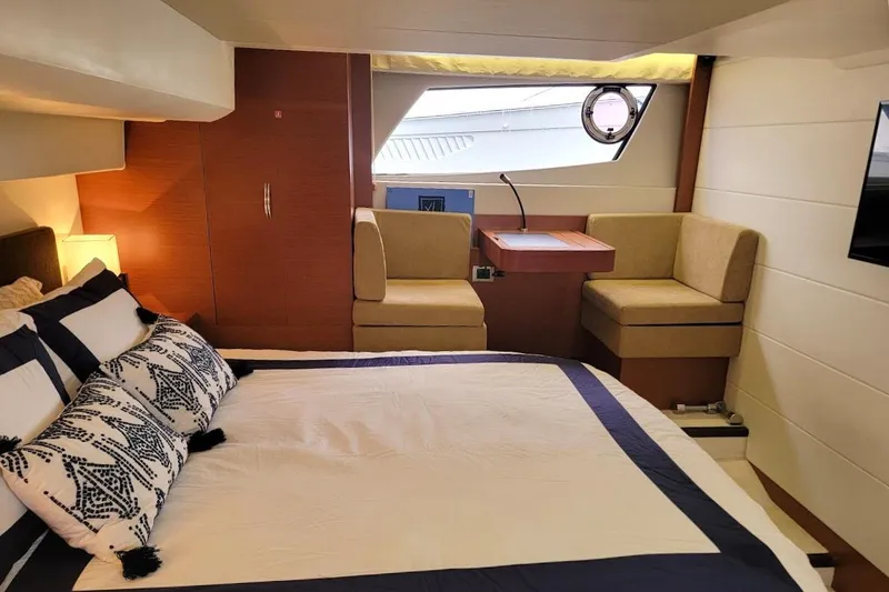 Slide: The Image of Luxurious interior of 2013 Prestige 500 S yacht with elegant bedding and seating area. - 16