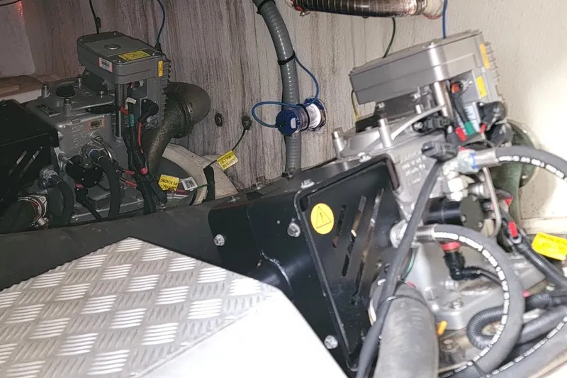 Slide: The Image of Engine room of a 2013 Prestige 500 S yacht, showcasing mechanical components and wiring. - 28