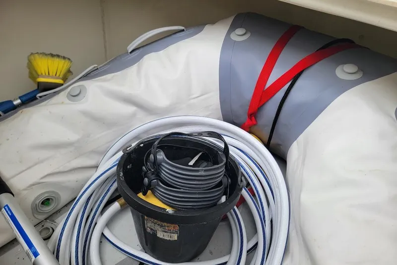 Slide: The Image of Storage compartment with coiled hose, bucket, and cleaning brush on a 2013 Prestige 500 S. - 29