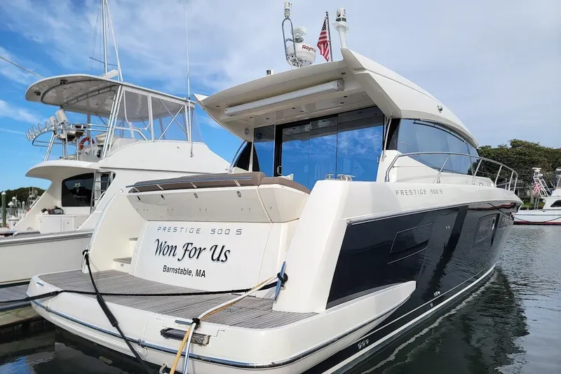 Slide: The Image of 2013 Prestige 500 S yacht docked, rear view, named "Won For Us," Barnstable, MA. - 31
