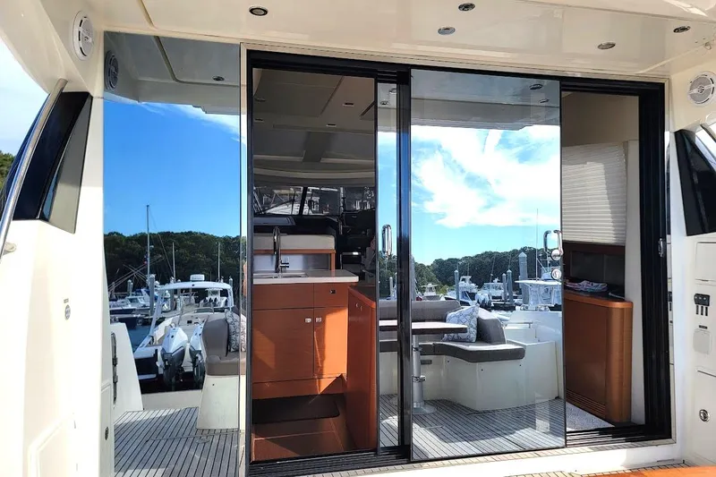 Slide: The Image of 2013 Prestige 500 S yacht interior with sliding glass doors and luxurious seating area. - 34