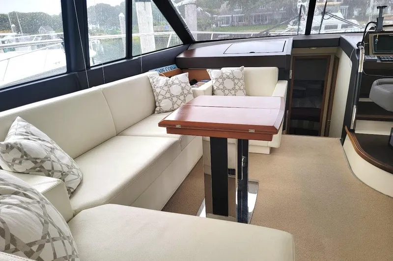 Slide: The Image of Luxurious interior of 2013 Prestige 500 S yacht with elegant seating and wooden table. - 36