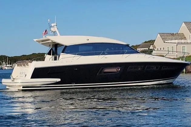 Slide: The Image of 2013 Prestige 500S yacht on calm water near coastal homes. - 38