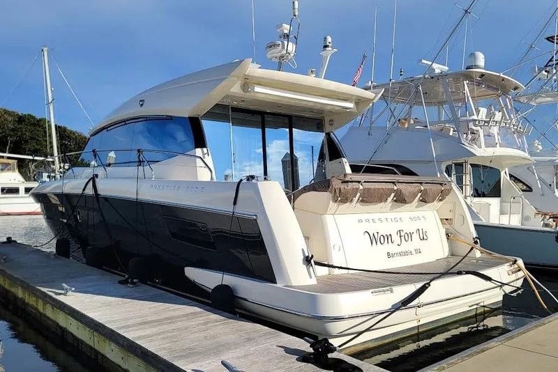 Slide: The Image of 2013 Prestige 500 S yacht docked at marina, clear sky, luxury vessel. - 39