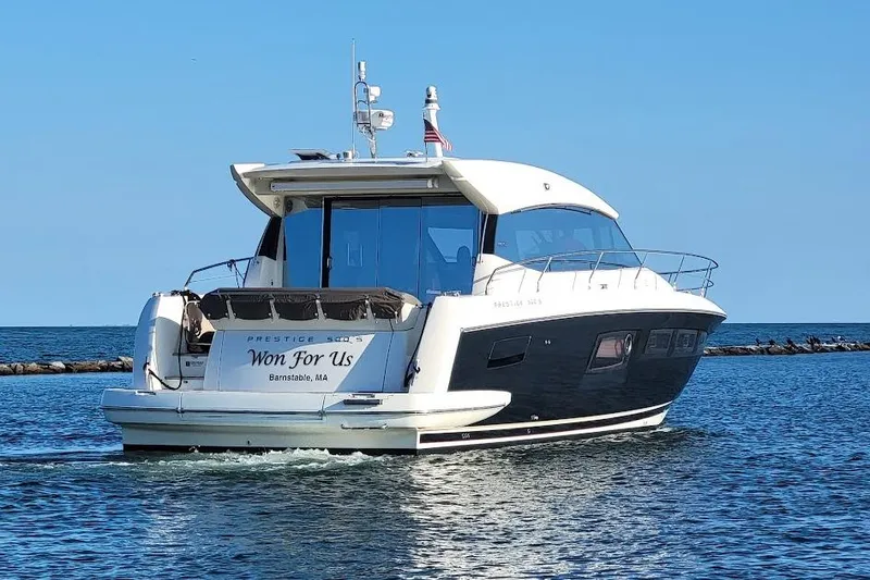 Slide: The Image of 2013 Prestige 500 S yacht cruising on open water, rear view. - 4