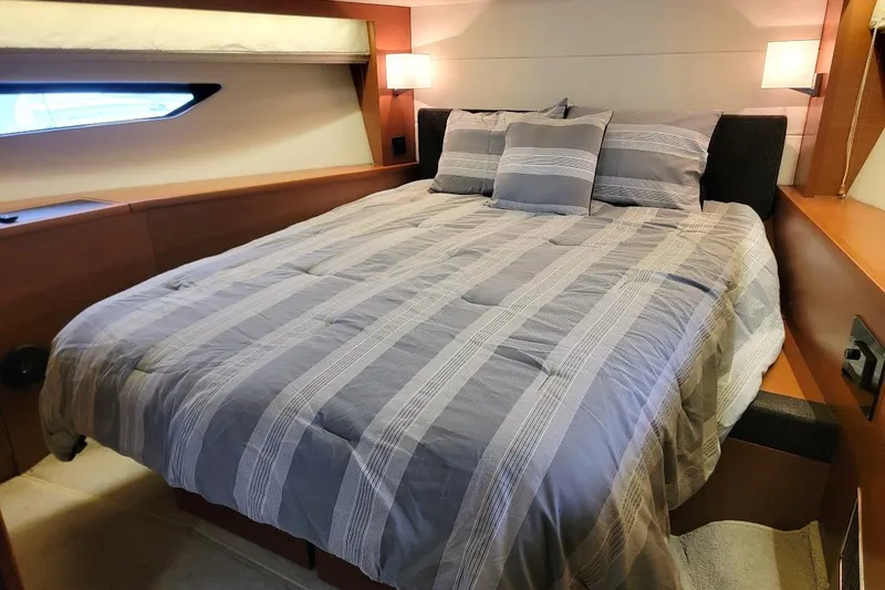Slide: The Image of Luxurious bedroom interior of 2013 Prestige 500 S yacht with striped bedding. - 9