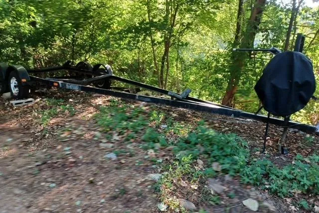 Slide: The Image of Trailer for 1996 McGregor 26 boat in a wooded area. - 13