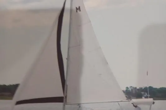 Slide: The Image of Sailboat on water, McGregor 26 model, 1996, with white sails and visible "M" logo. - 3