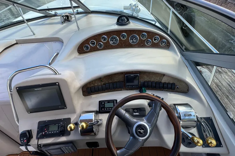 Slide: The Image of 1999 Searay 340 Sundancer helm with gauges, controls, and navigation equipment. - 5