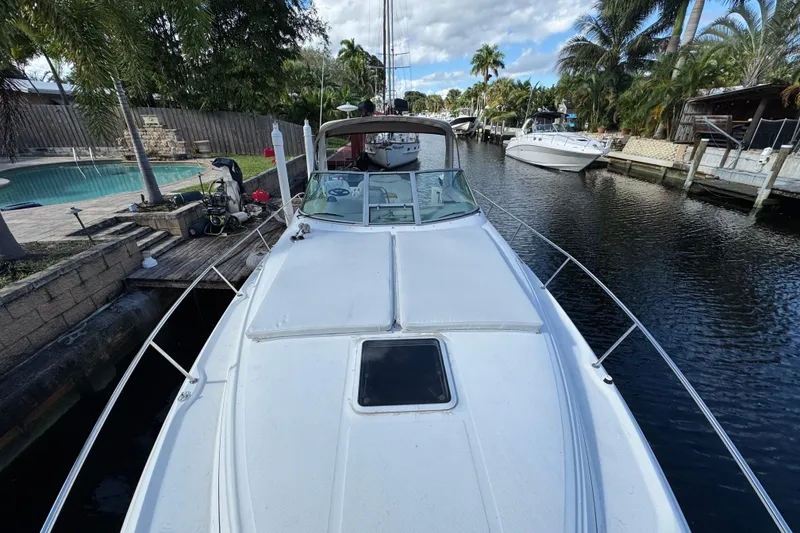 Slide: The Image of 1999 Searay 340 Sundancer docked in a scenic canal with palm trees. - 6