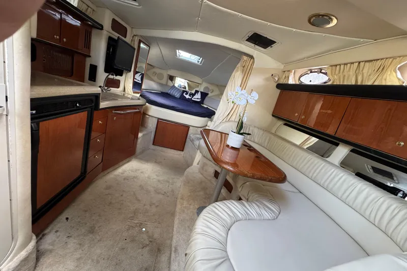 Slide: The Image of Interior of 1999 Searay 340 Sundancer yacht with cozy seating and elegant wood finishes. - 8
