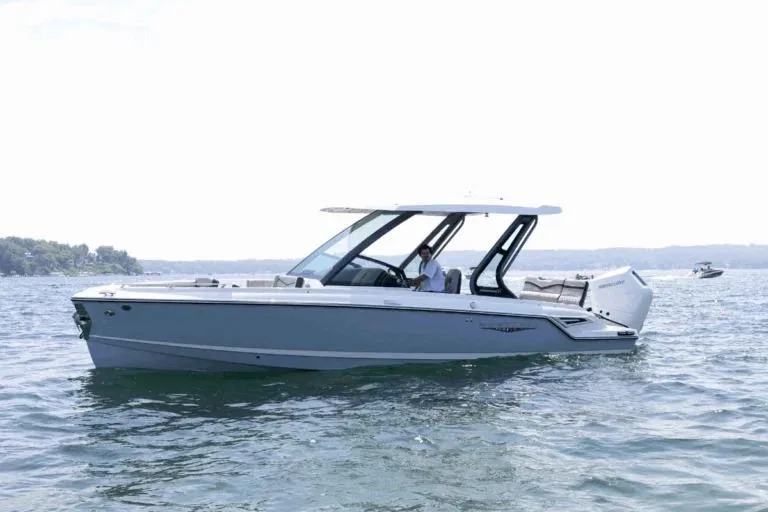 The Image of 2026 Monterey Elite 27 OB boat cruising on a calm lake. - 0