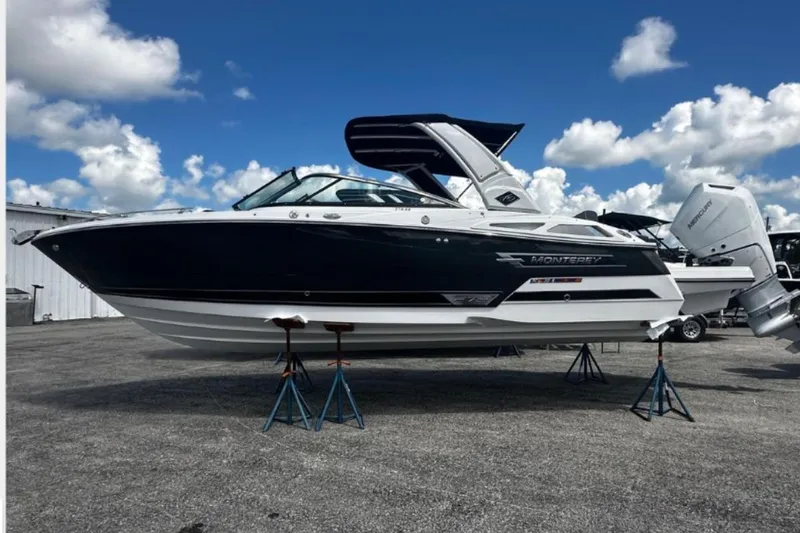 The Image of 2026 Monterey 275SS Super Sport boat on stands under a blue sky. - 0