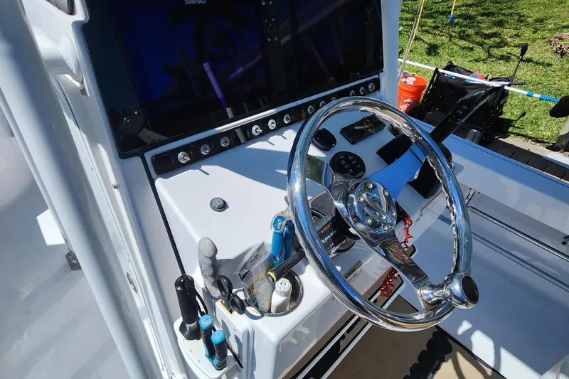 Slide: The Image of 2018 Sportsman Masters 247 Bay Boat dashboard with steering wheel and controls. - 12
