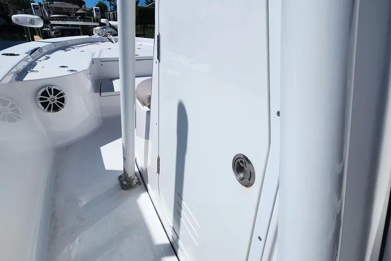 Slide: The Image of 2018 Sportsman Masters 247 Bay Boat interior, featuring white deck and speaker system. - 13