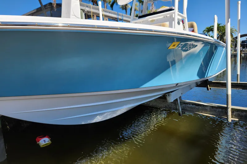Slide: The Image of 2018 Sportsman Masters 247 Bay Boat in blue, docked above water. - 18
