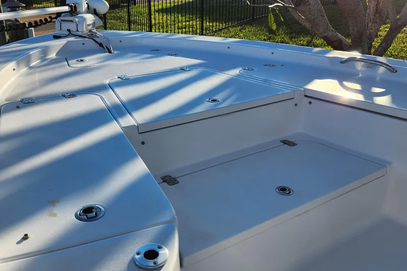 Slide: The Image of 2018 Sportsman Masters 247 Bay Boat deck with storage compartments and fishing equipment. - 19