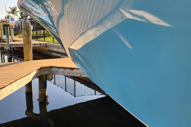 Slide: The Image of 2018 Sportsman Masters 247 Bay Boat docked, reflecting on calm water. - 22