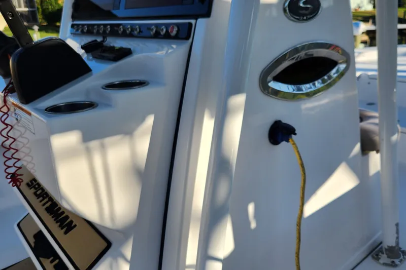 Slide: The Image of 2018 Sportsman Masters 247 Bay Boat console with controls and cup holders. - 24