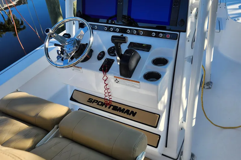 Slide: The Image of 2018 Sportsman Masters 247 Bay Boat helm with steering wheel and controls. - 27