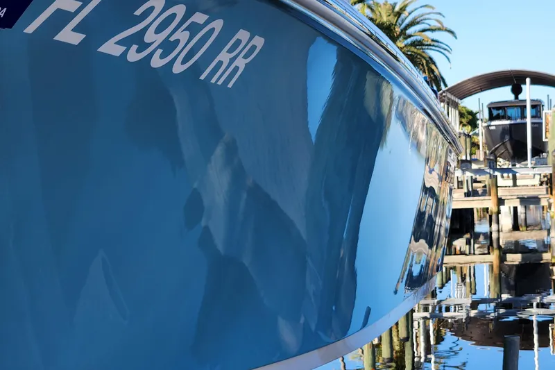 Slide: The Image of 2018 Sportsman Masters 247 Bay Boat docked, reflecting water and surroundings. - 28