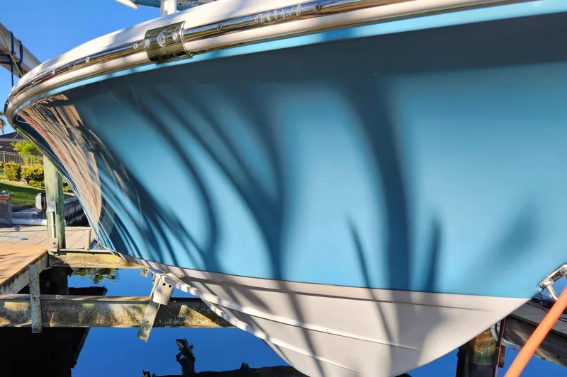 Slide: The Image of 2018 Sportsman Masters 247 Bay Boat in vibrant blue, docked under clear skies. - 29