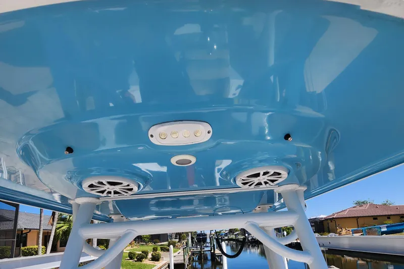 Slide: The Image of 2018 Sportsman Masters 247 Bay Boat with blue T-top and speakers. - 5
