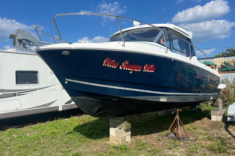 Slide: The Image of 2020 Jeanneau NC Sport 795 boat on blocks, blue hull, sunny day. - 0