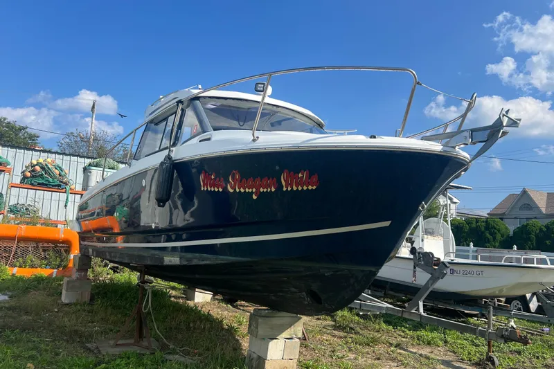 Slide: The Image of 2020 Jeanneau NC Sport 795 boat on stands, blue sky background. - 1