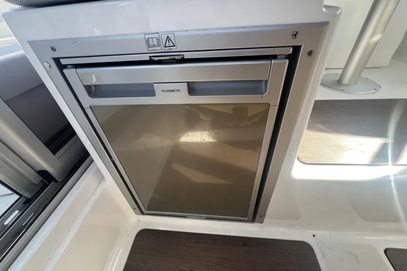 Slide: The Image of Compact Dometic fridge inside 2020 Jeanneau NC Sport 795 boat interior. - 10