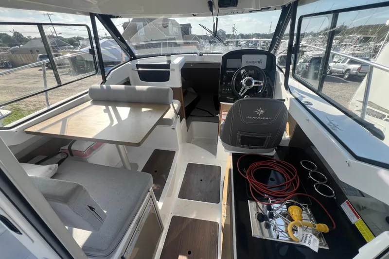 Slide: The Image of Interior of 2020 Jeanneau NC Sport 795 boat with steering wheel and seating area. - 3