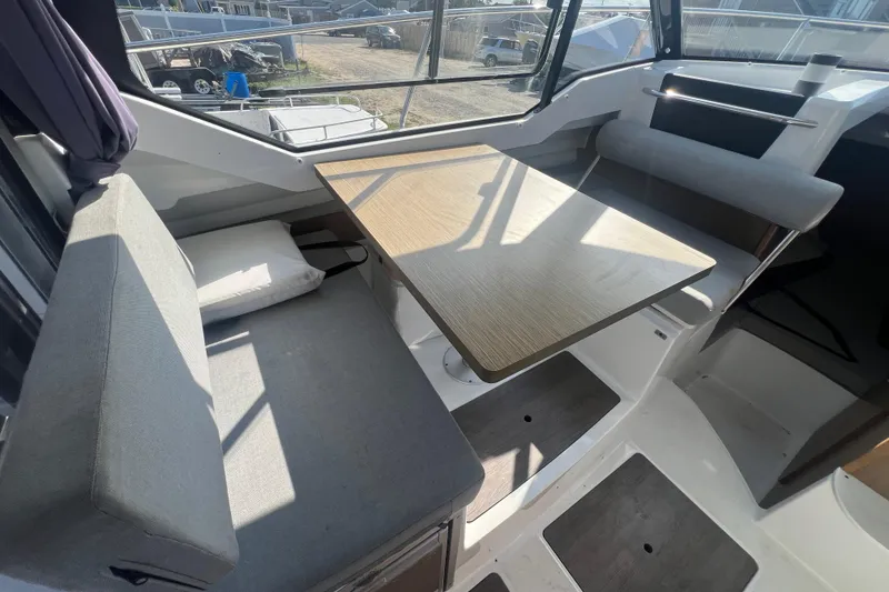 Slide: The Image of Interior of 2020 Jeanneau NC Sport 795 boat with seating and table. - 7
