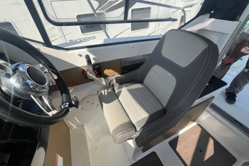 Slide: The Image of Interior of 2020 Jeanneau NC Sport 795 boat showing steering wheel and captain's seat. - 8