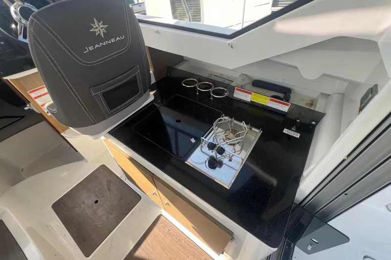 Slide: The Image of Interior of 2020 Jeanneau NC Sport 795 boat with compact kitchen area. - 9